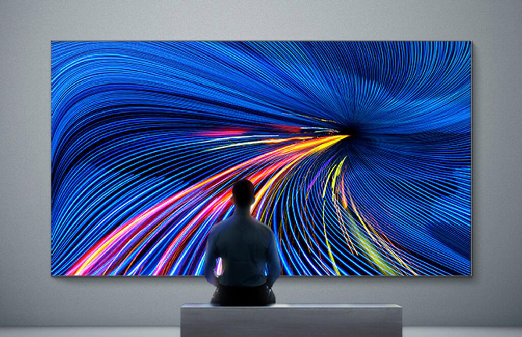 Silhouette of a person sitting facing a large TV screen, Samsung's LED Video Wall